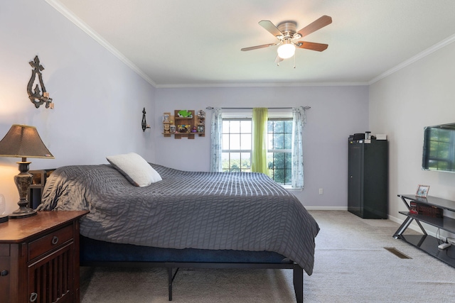 bedroom featuring ceiling fan, light colored carpet, and crown molding