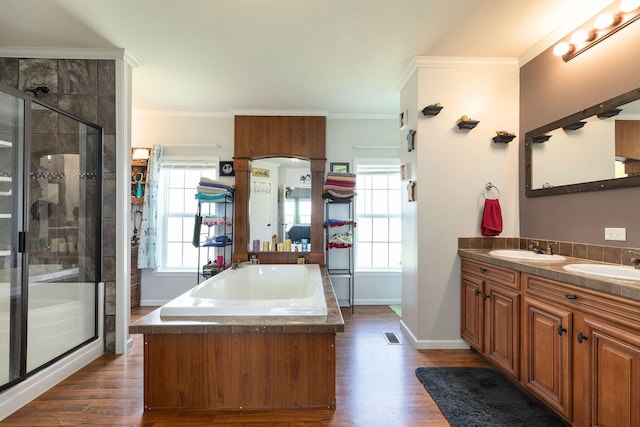 bathroom with wood-type flooring, shower with separate bathtub, plenty of natural light, and crown molding