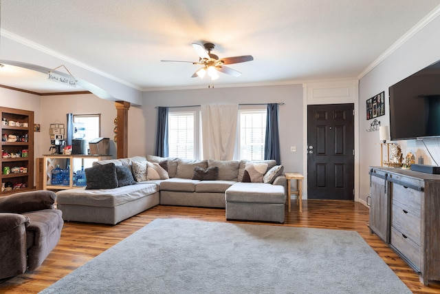 living room with ornate columns, ceiling fan, ornamental molding, and light hardwood / wood-style floors