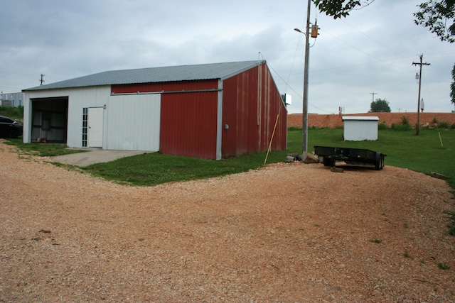 view of outdoor structure featuring a lawn