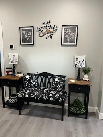 sitting room with hardwood / wood-style flooring