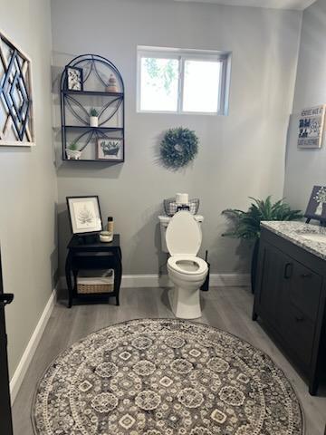 bathroom featuring hardwood / wood-style floors, vanity, and toilet