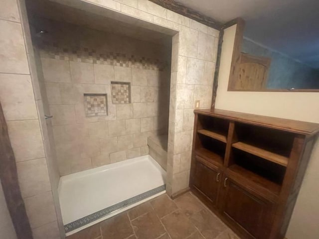 bathroom with a shower and tile walls