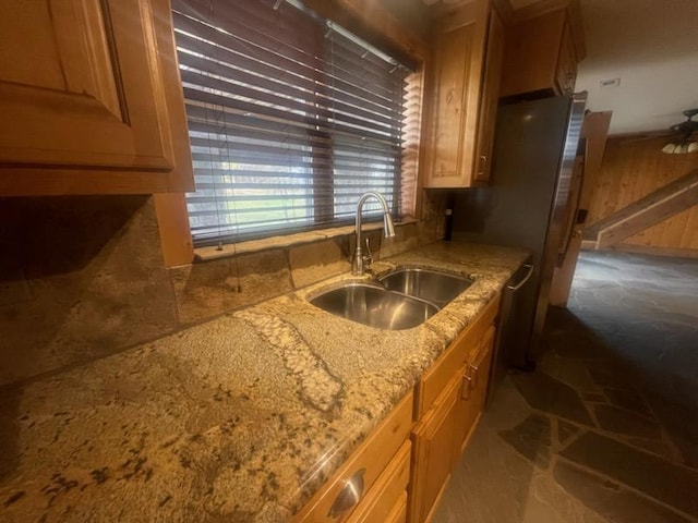 kitchen with light stone countertops and sink