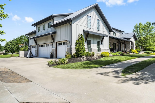 5233 S Stirling Way, Springfield, MO 65809 - view of home's exterior with a lawn, driveway, stone siding, board and batten siding, and an attached garage