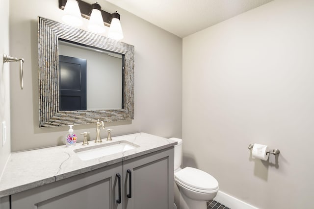 bathroom featuring vanity, toilet, a textured ceiling, and tile patterned floors