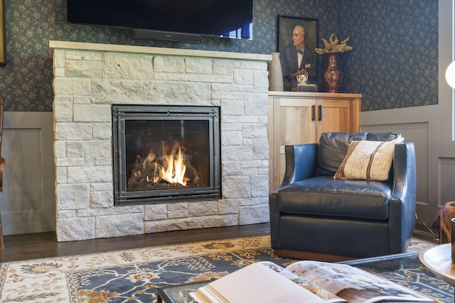 5233 S Stirling Way, Springfield, MO 65809 - sitting room featuring a fireplace, wallpapered walls, wood finished floors, and wainscoting