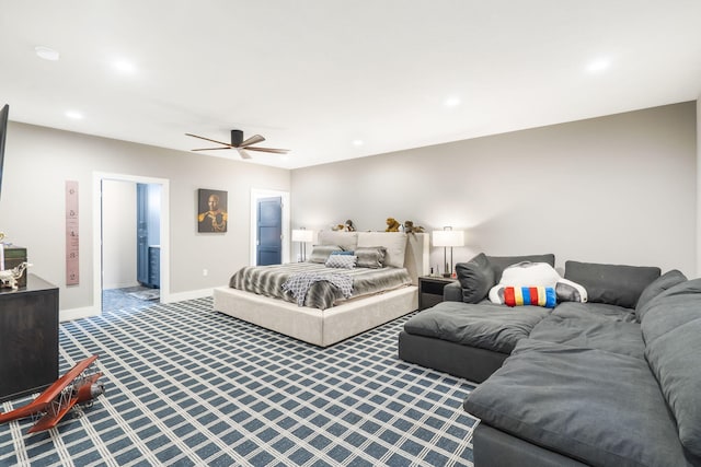 carpeted bedroom featuring ensuite bath and ceiling fan