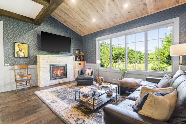 living room featuring a fireplace, dark hardwood / wood-style floors, lofted ceiling with beams, and a healthy amount of sunlight