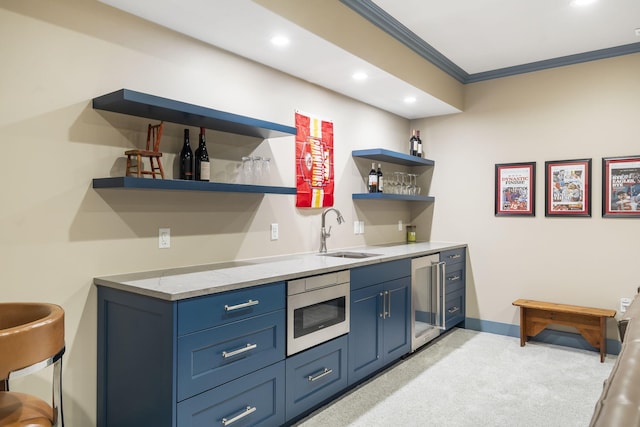 bar with crown molding, blue cabinetry, light carpet, sink, and appliances with stainless steel finishes