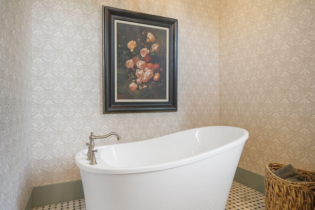 bathroom with tile patterned flooring and a bath