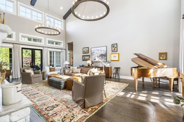 5233 S Stirling Way, Springfield, MO 65809 - living area featuring baseboards, a towering ceiling, an inviting chandelier, and dark wood-type flooring