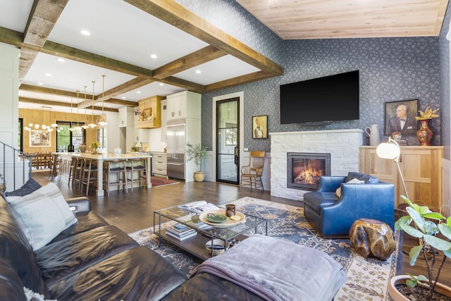 5233 S Stirling Way, Springfield, MO 65809 - living area featuring beam ceiling, a chandelier, wallpapered walls, a fireplace, and dark wood-type flooring