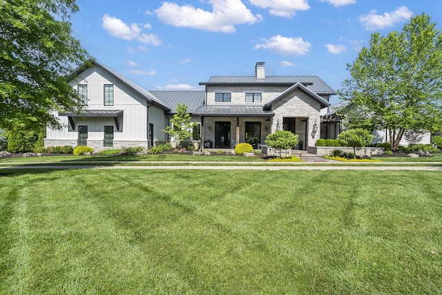 modern farmhouse style home featuring a front lawn