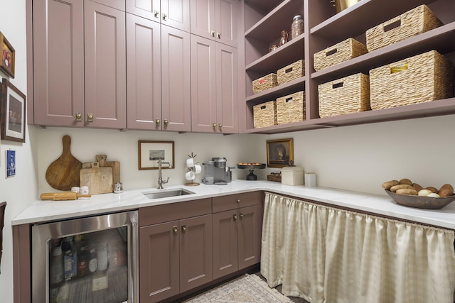 clothes washing area featuring beverage cooler and sink