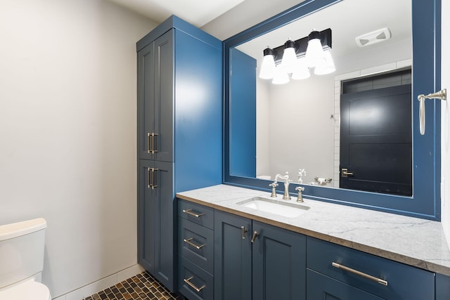 bathroom featuring vanity, tile patterned flooring, and toilet