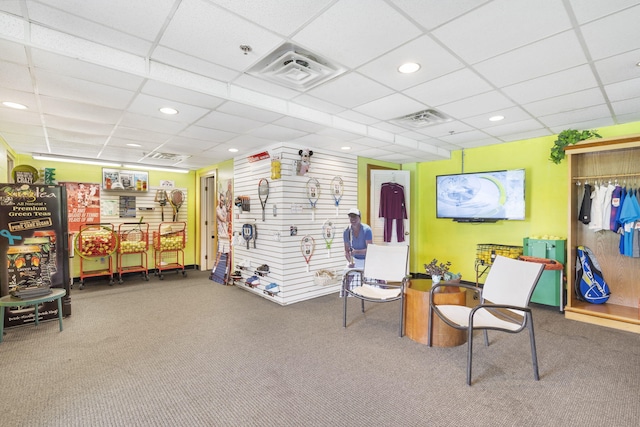 interior space with carpet floors and a drop ceiling