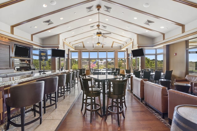 dining area featuring ceiling fan, plenty of natural light, and dark hardwood / wood-style flooring