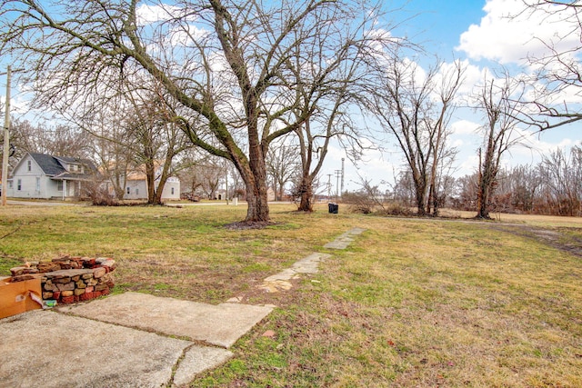 view of yard with a fire pit