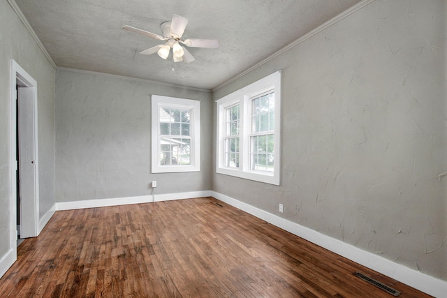 spare room featuring wood-type flooring, a textured ceiling, ornamental molding, and ceiling fan