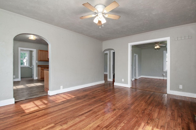 spare room with ceiling fan, dark hardwood / wood-style floors, and ornamental molding