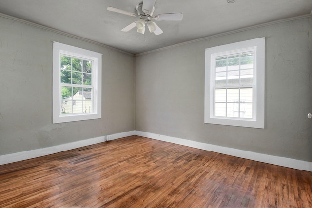 unfurnished room with ceiling fan, crown molding, hardwood / wood-style floors, and a healthy amount of sunlight