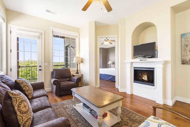 living room with hardwood / wood-style floors and ceiling fan