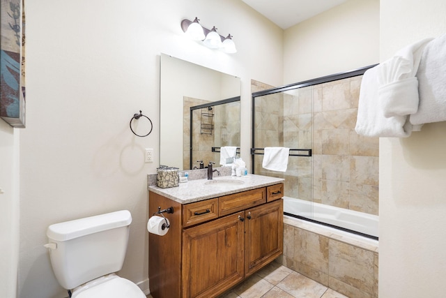 full bathroom featuring vanity, tile patterned flooring, toilet, and enclosed tub / shower combo