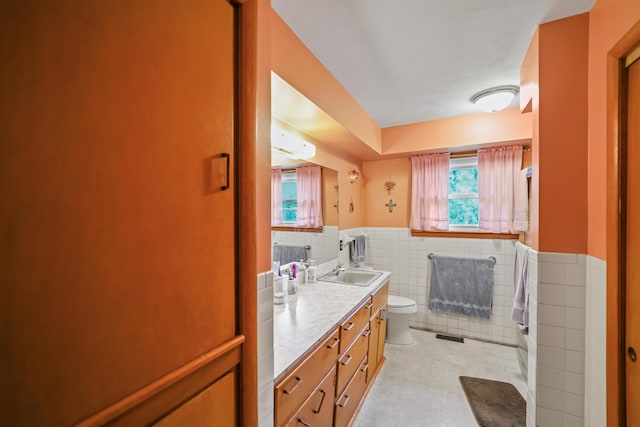 4587 E Farm Road 136, Springfield, MO 65809 - bathroom with visible vents, toilet, vanity, tile walls, and wainscoting