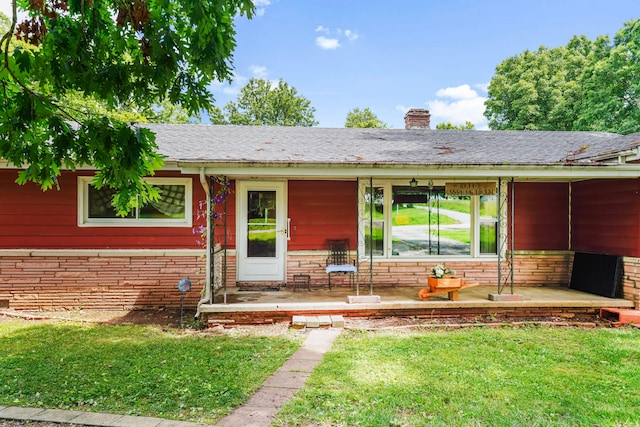 doorway to property with a yard