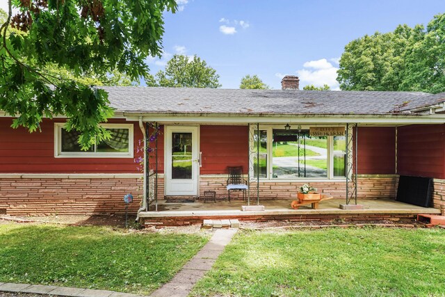 4587 E Farm Road 136, Springfield, MO 65809 - doorway to property with stone siding, a chimney, covered porch, a shingled roof, and a yard