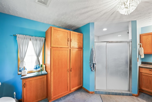 4587 E Farm Road 136, Springfield, MO 65809 - full bath with visible vents, vanity, a textured ceiling, a stall shower, and a notable chandelier
