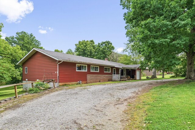 4587 E Farm Road 136, Springfield, MO 65809 - single story home featuring a chimney, a garage, dirt driveway, and a front yard