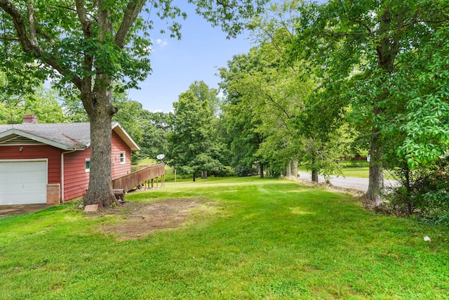 view of yard featuring a garage and a deck