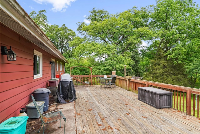 wooden terrace featuring a grill