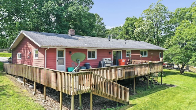 4587 E Farm Road 136, Springfield, MO 65809 - rear view of house featuring a chimney, a wooden deck, a shingled roof, stairway, and a yard