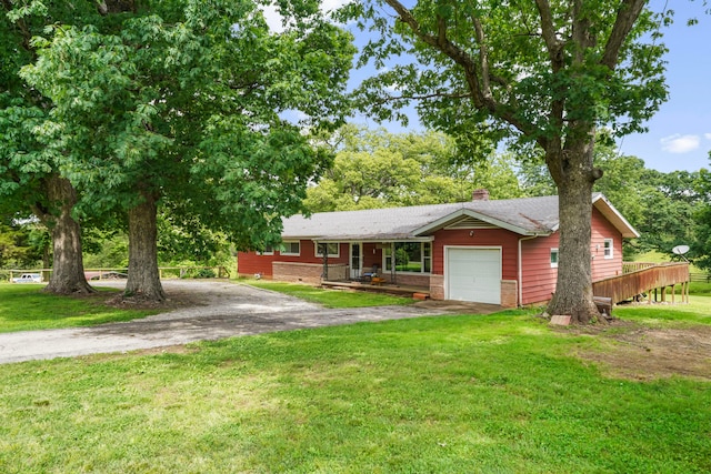 single story home featuring a garage and a front lawn