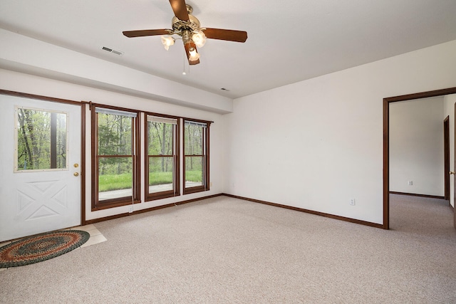 spare room with ceiling fan and light carpet