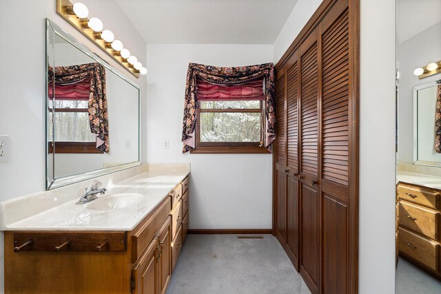 full bathroom featuring a closet, vanity, and plenty of natural light