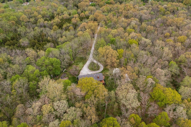 birds eye view of property featuring a view of trees