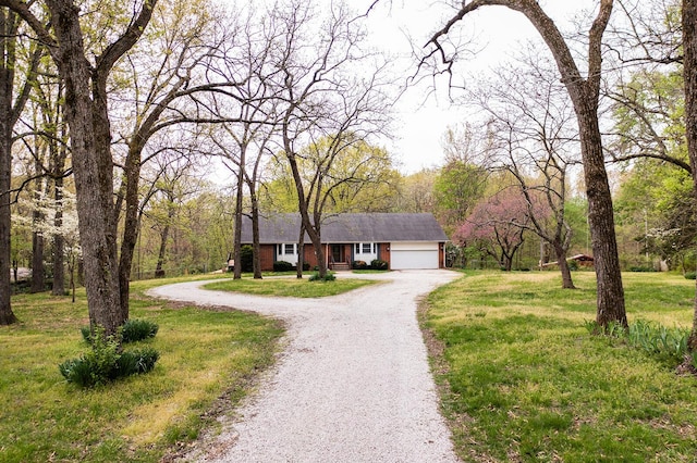 ranch-style home featuring an attached garage, driveway, and a front lawn