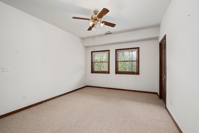 unfurnished room with ceiling fan and light colored carpet