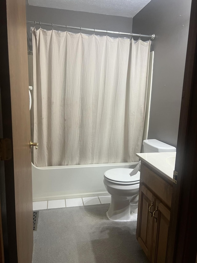 bathroom with tile patterned floors, toilet, vanity, and shower / bath combination with curtain
