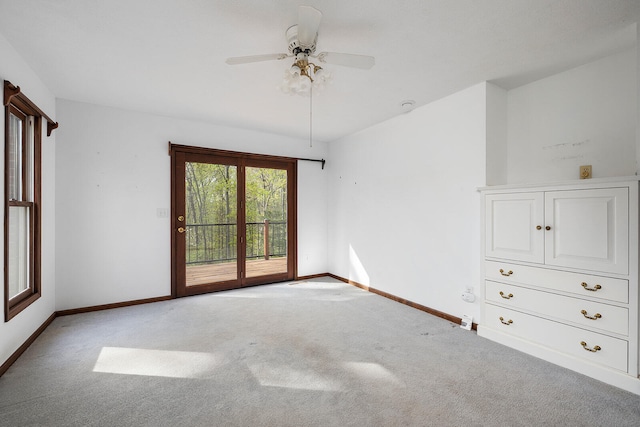 spare room with ceiling fan and light carpet