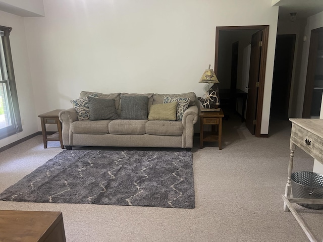 carpeted living room with baseboards