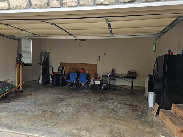 2800 Briaroaks Ln, Joplin, MO 64804 - garage featuring freestanding refrigerator