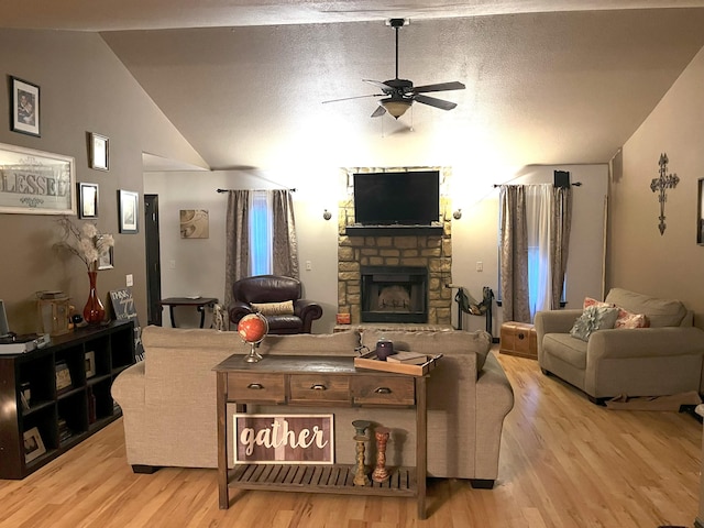 2800 Briaroaks Ln, Joplin, MO 64804 - living room featuring vaulted ceiling, a ceiling fan, light wood-style flooring, and a stone fireplace