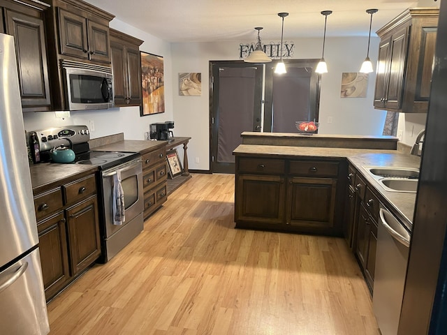 2800 Briaroaks Ln, Joplin, MO 64804 - kitchen featuring light wood-type flooring, stainless steel appliances, a peninsula, and dark brown cabinetry