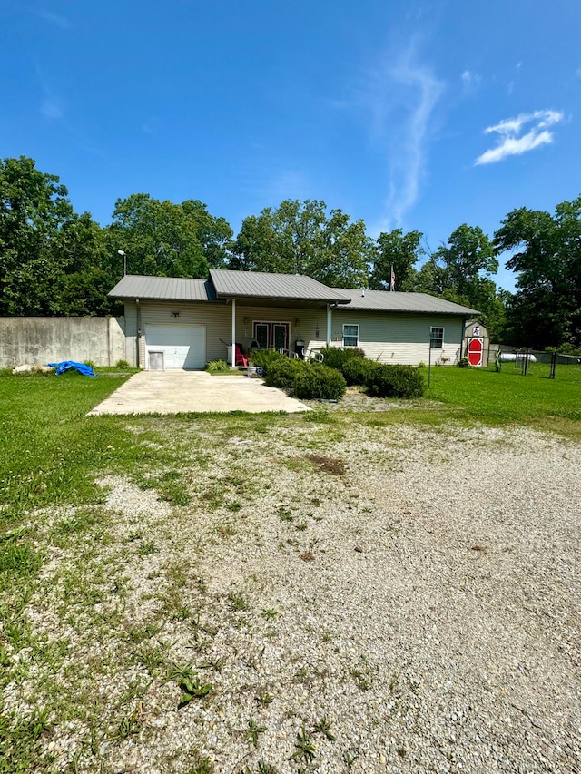 single story home featuring a front yard and a garage