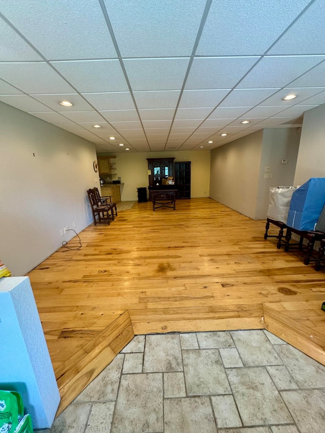 interior space featuring light wood-type flooring and a paneled ceiling